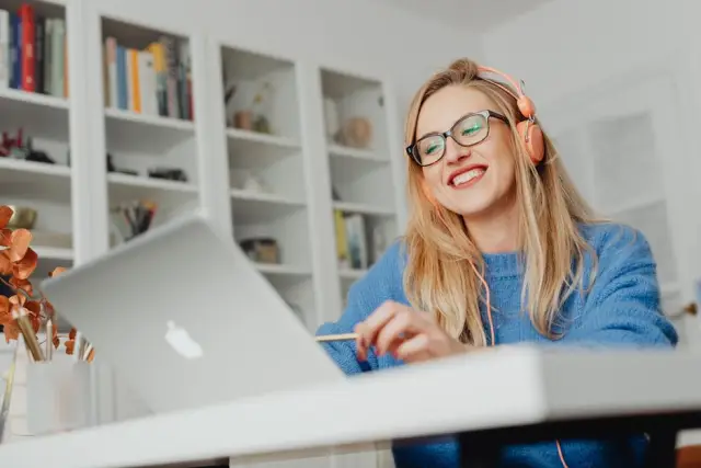 Mulher loira comparando planos no laptop